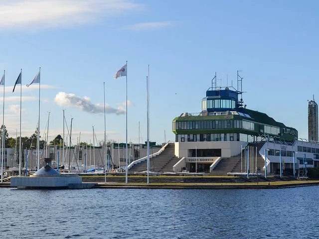 A modern building with a multi-level structure near a marina.